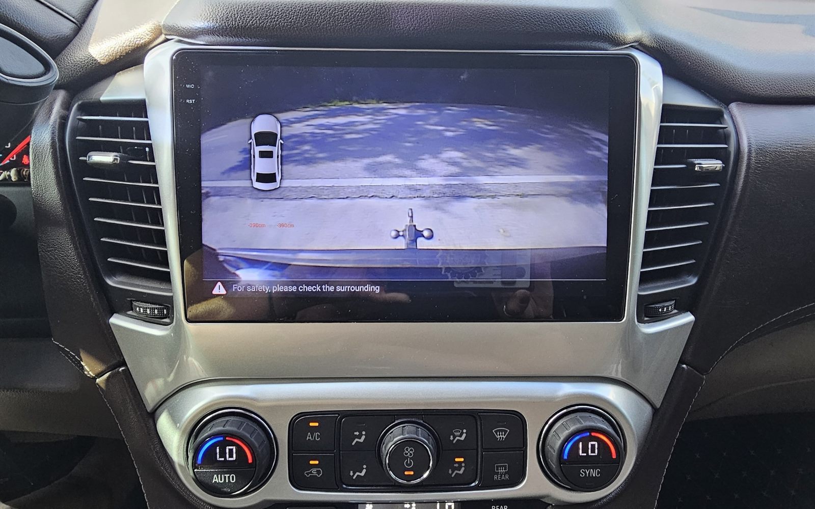 2015 Chevrolet Tahoe after installation — 9-inch head unit showing the reconnected OEM backup camera